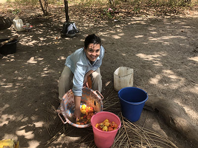 Jordyn, the blog author, washing cashews in a cashew orchard. 