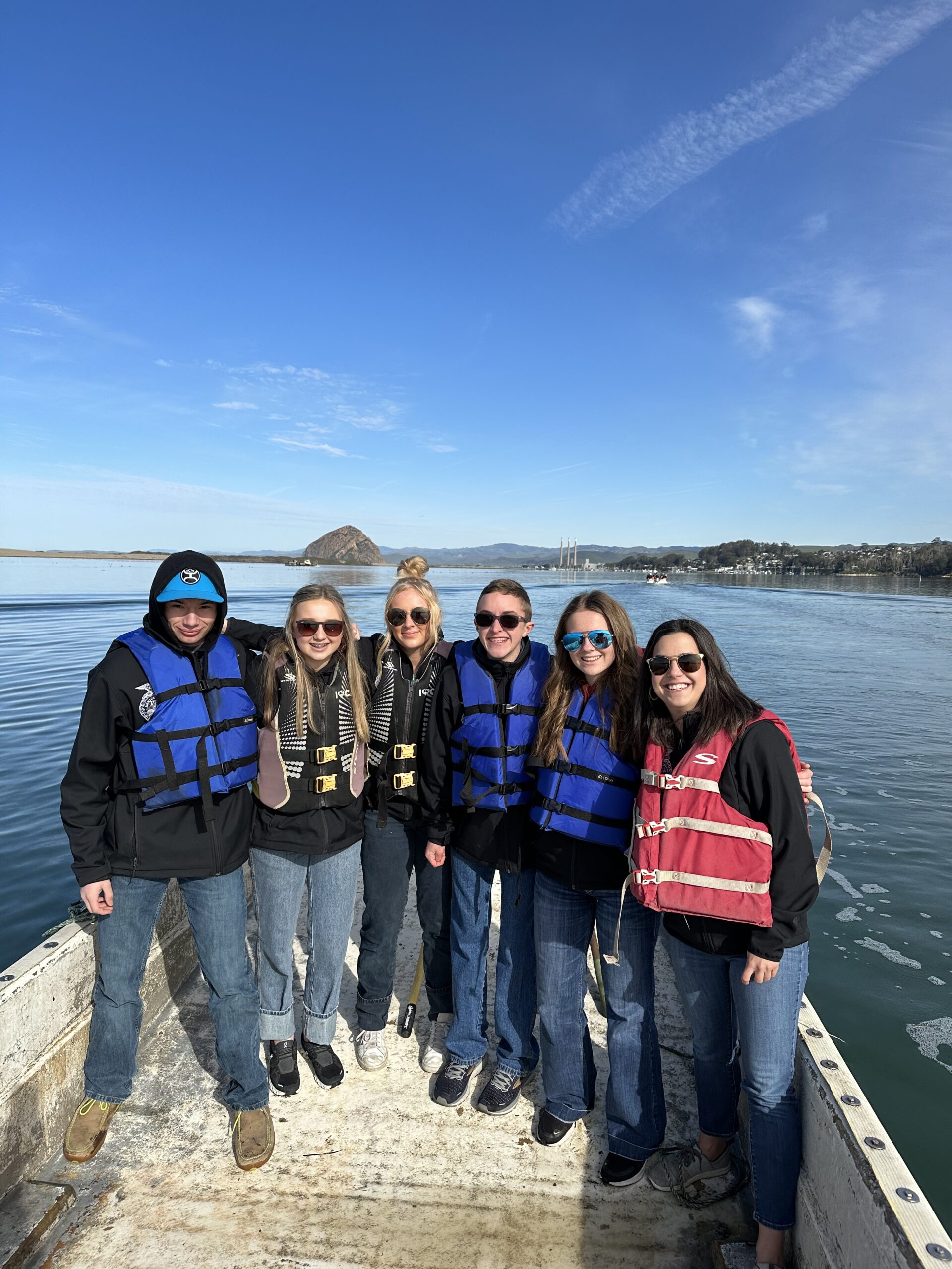 Attendees of the Oregon FFA tour of California agriculture pose on a boat during a tour with Morro Bay Oyster Company