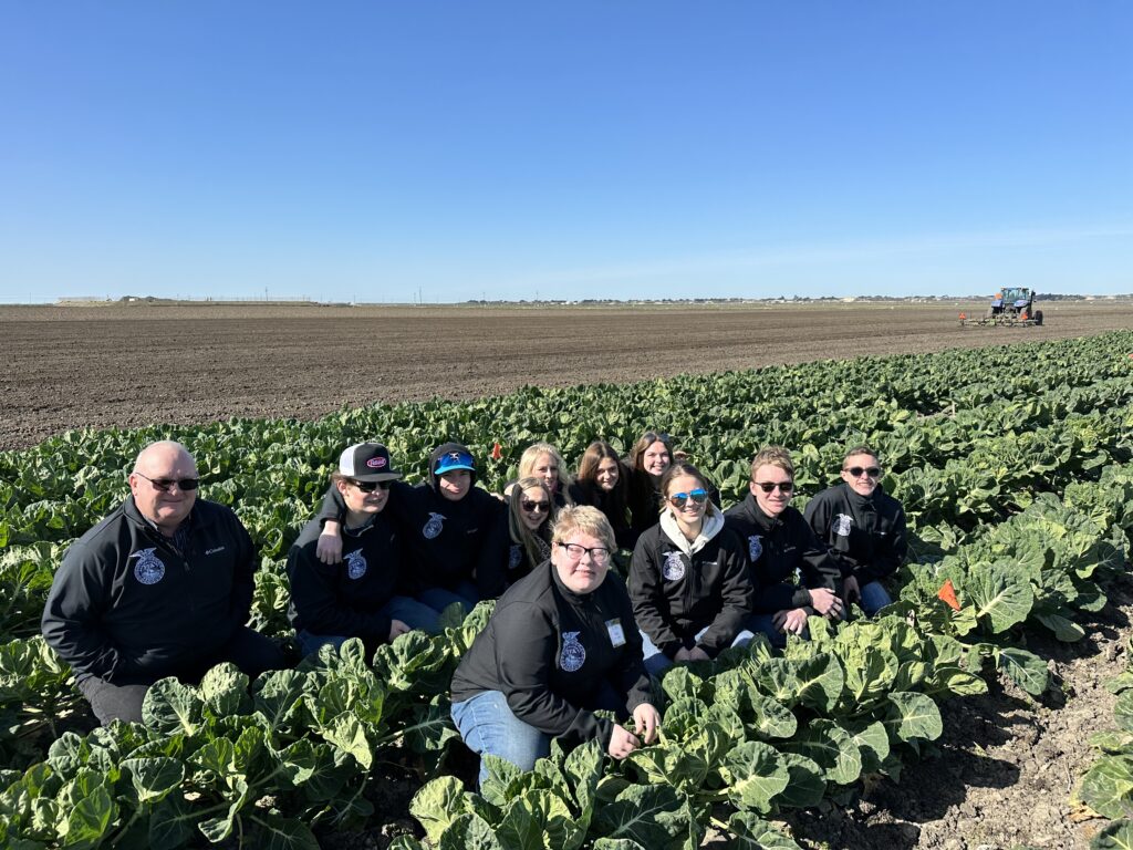 Oregon FFA members pose in a field of Brussels sprouts in the Salinas Valley of California.